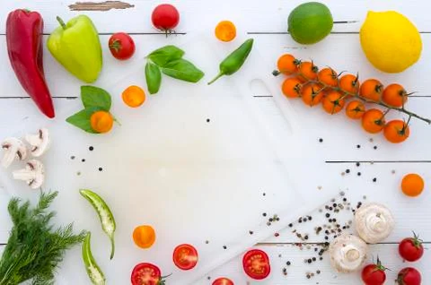 Flat lay Frame of vegetables and spices on white wooden background Stock Photos