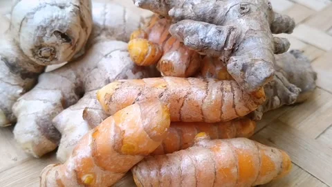 Flat Lay of Fresh Ginger Red Ginger and Whole Turmeric on Bamboo Mat Stock Footage 340538213