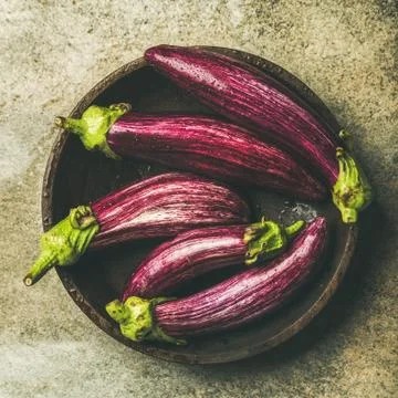 Flat-lay of fresh raw Fall harvest purple eggplants, square crop Stock Photos