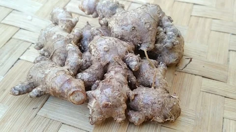 Flat Lay of Fresh Red Ginger Roots on Bamboo Mat Stock Footage 340619113