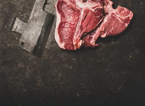 Flat-lay of fresh uncooked beef meat t-bone steaks, copy space Stock Photos