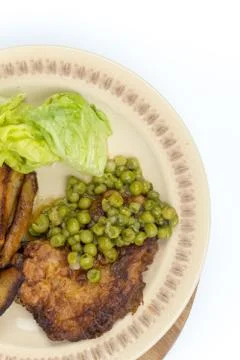 Flat lay fried steak green peas potatoes Stock Photos