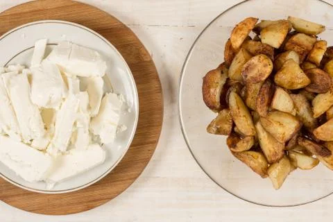Flat lay fried young potatoes with white cheese Stock Photos