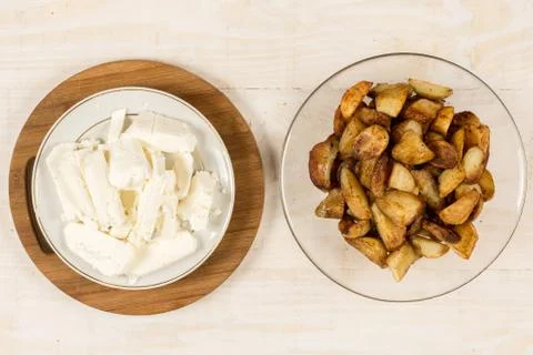 Flat lay fried young potatoes with white cheese Stock Photos