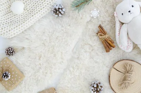 Flat lay fur background with pine cone fir branch,rope,rabbit toy, cinnamon.Top Stock Photos