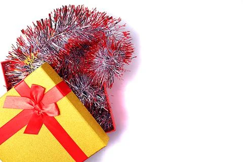 Flat lay with a gift box from which red-silver tinsel out to decorate the Chr Stock Photos