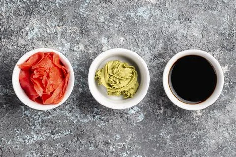 Flat lay ginger wasabi soy sauce bowls Stock Photos