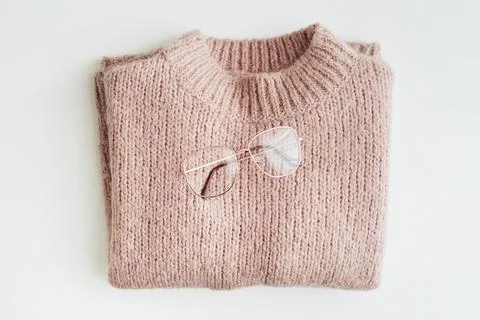 Flat lay of glasses on a pink knitted sweater Stock Photos