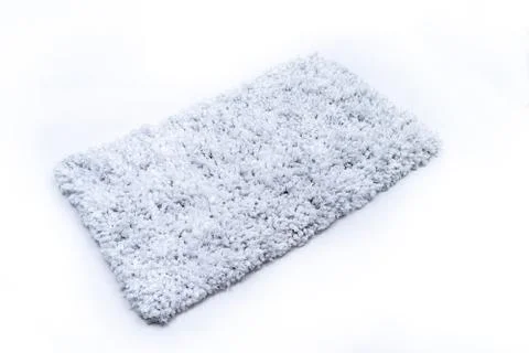 Flat lay, grey color of microfiber bath mat isolated on white background Stock Photos