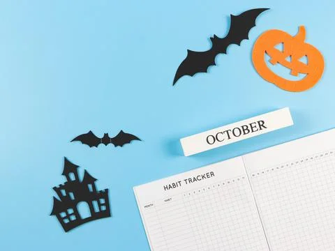 Flat lay of habit tracker book, wooden calendar October,  halloween decoratio Stock Photos