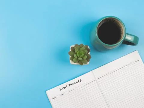 Flat lay of habit tracker book with  blue  cup of black coffee and succulent  Stock Photos