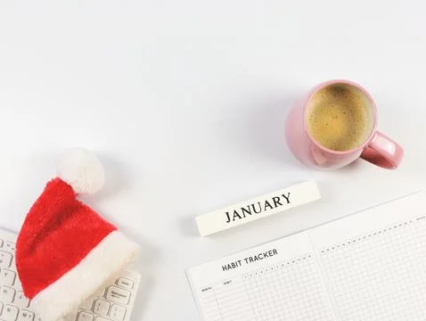 Flat lay of habit tracker book, wooden calendar January, red Christmas Sant.. Stock Photos