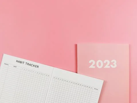 Flat lay of habit tracker book on pink diary or planner 2023 on pink backgr.. Stock Photos