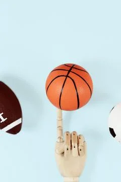 Flat lay of hand holding small basketball ball minimal creative concept. Stock Photos