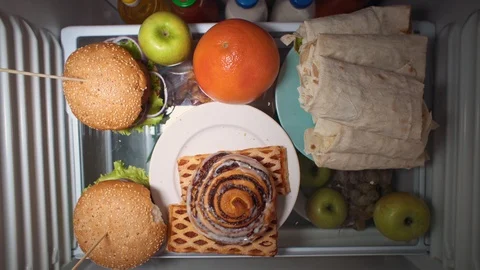 Flat lay of the hand take food at night with on the shelves of the refrigerator. Stock Footage 104729270