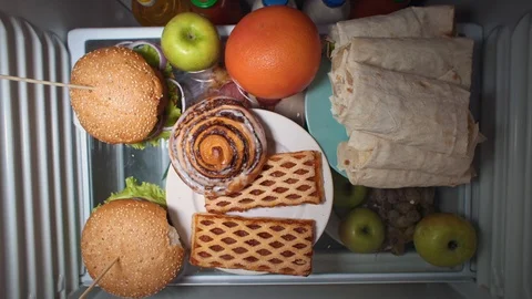 Flat lay of the hand take food at night with on the shelves of the refrigerator. Stock Footage 104729405