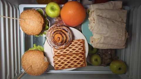 Flat lay of the hand take food at night with on the shelves of the refrigerator. Stock Footage 104729489