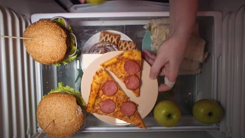 Flat lay of the hand take food at night with on the shelves of the refrigerator. Stock Footage 105470054