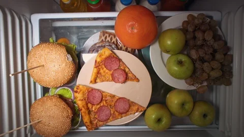 Flat lay of the hand take food at night with on the shelves of the refrigerator. Stock Footage 106993492