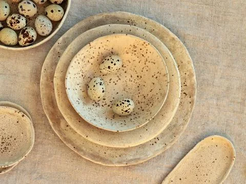 Flat lay of handmade speckled ceramic plates Stock Photos