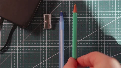 Flat lay of hands neatly organizing school stationary supplies on desk Stock Footage 340139160