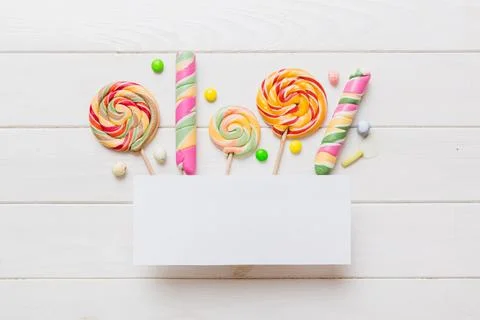 Flat lay holiday composition. Paper blank, lollipop, birthday decorations o.. Stock Photos