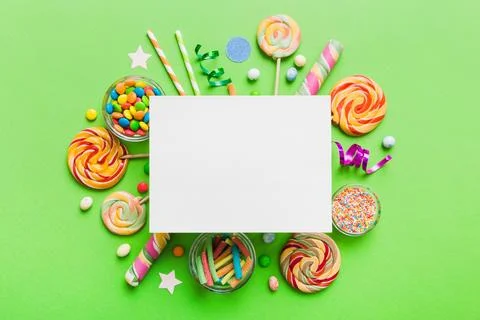 Flat lay holiday composition. Paper blank, lollipop, birthday decorations o.. Stock Photos