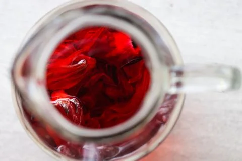 Flat Lay of Iced Red Roselle Tea in Glass Pitcher and Empty Glass, Healthy .. Stock Photos