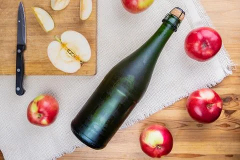 Flat lay with icy cooled corked cidre bottle on rustic wooden table. Stock Photos