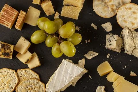 Flat lay image of aged artisan French, Italian and Swiss cheese assortment Stock Photos