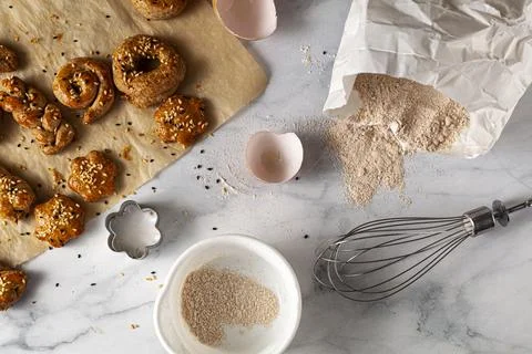 Flat lay image of  fresh handmade pastry cooling on baking paper with seeds s Stock Photos
