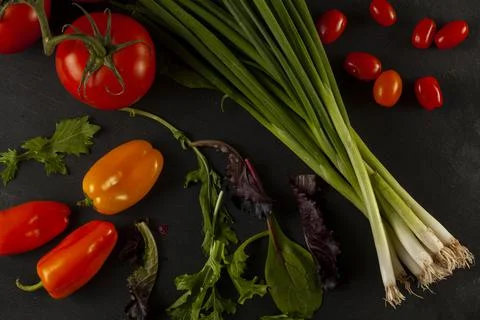 Flat lay image of green leafy vegetable mix, arugula leafs, tomato on vine, Stock Photos