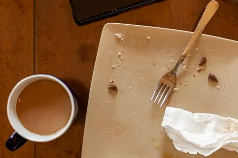 A flat lay image of a kitchen table after a quick breakfast on a workday. Stock Photos