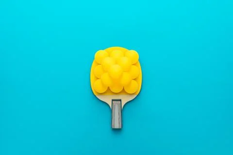 Flat lay image of table tennis paddle with many balls central composition Stock Photos