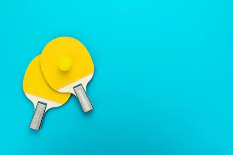 Flat lay image of two table tennis paddles with a ball Stock Photos