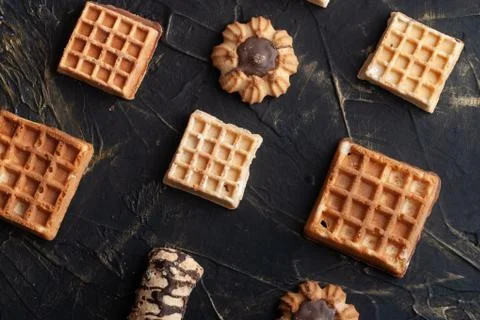 Flat lay image of the wafer on the dark table, pattern cookies, Stock Photos