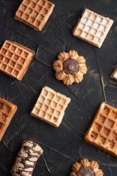 Flat lay image of the wafer on the dark table, pattern cookies, Stock Photos