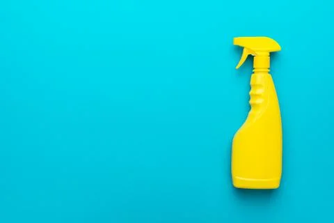 Flat lay image of yellow plastic dispenser on blue background with copy space Stock Photos