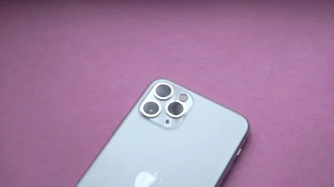 Flat lay with Iphone 11 Pro Silver, back with three camera's lenses Stock Footage 120991772