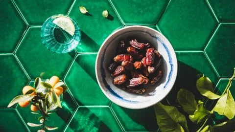 Flat-lay of Islamic Ramadan Iftar food over green tile table Stock Photos