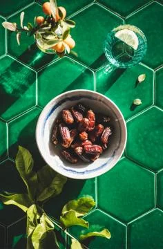 Flat-lay of Islamic Ramadan Iftar food over green tile Stock Photos