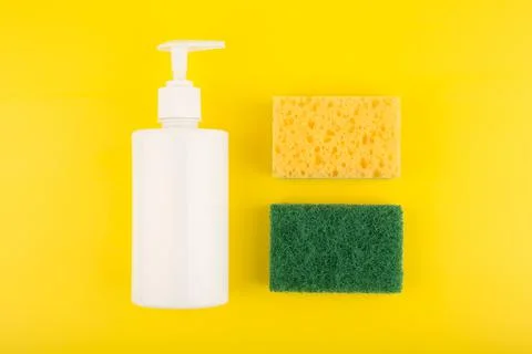Flat lay with kitchen detergent cleaning sponges on yellow background Stock Photos