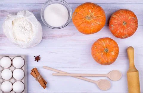Flat lay kitchen utensils and ingredients for cooking pumpkin pie. Stock Photos
