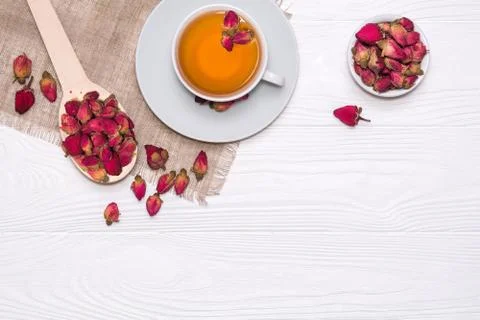 Flat lay layout with herbal tea with rosebuds. White cup with hot tea Stock Photos