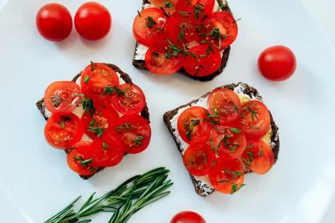 Flat lay on a light background, tomatoes and sandwiches Stock Photos