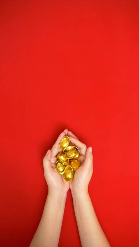 Flat lay looping footage of hand holding a lot of ancient Chinese gold bar Stock Footage 263020996
