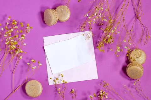 Flat Lay of Macarons with Flowers and Empty Note on Pink Background Stock Photos