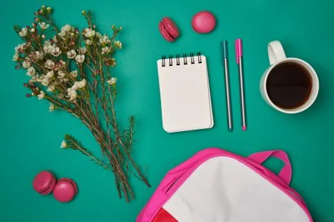 Flat lay with macaroons,coffee, notepad and flowers on real background Stock Photos