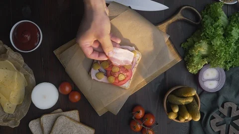 Flat lay of making the sandwich with sliced bacon, pickle and vegetables on the Stock Footage 113802284