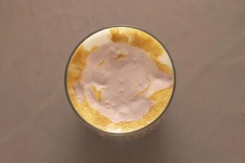 Flat lay of mango lassi emphasizing texture and vibrant pulp colors Stock Photos